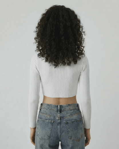 Back view of a woman wearing the Lauven Monaco Top, a white ribbed knit long sleeve cut out top.