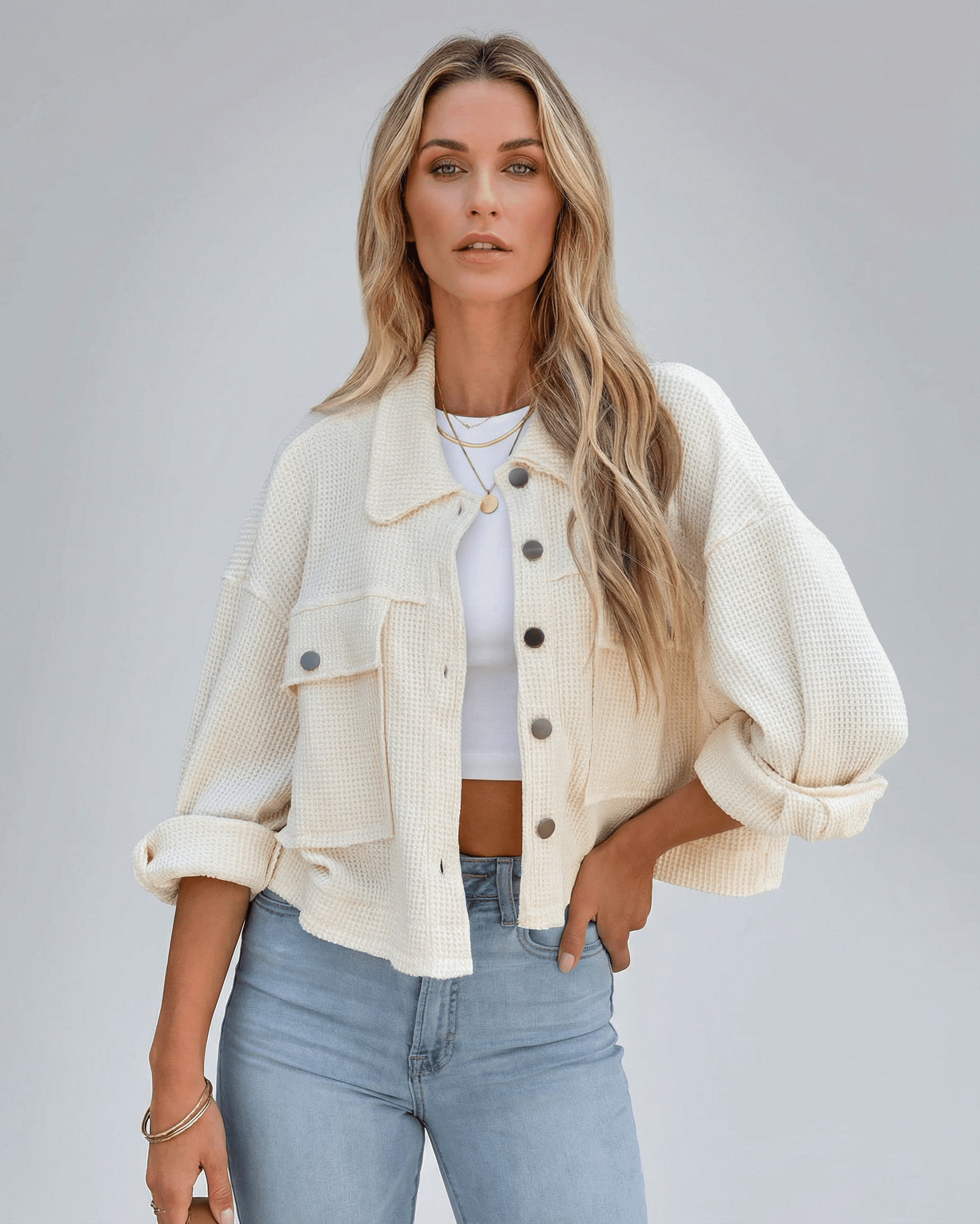 Sahara Jacket from Lauven – Women’s oversized cream cropped jacket styled casually with jeans.
