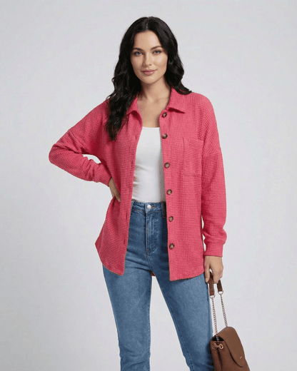 Woman wearing a pink Verona Jacket in waffle knit by Lauven, featuring a longline casual fit with button closure.