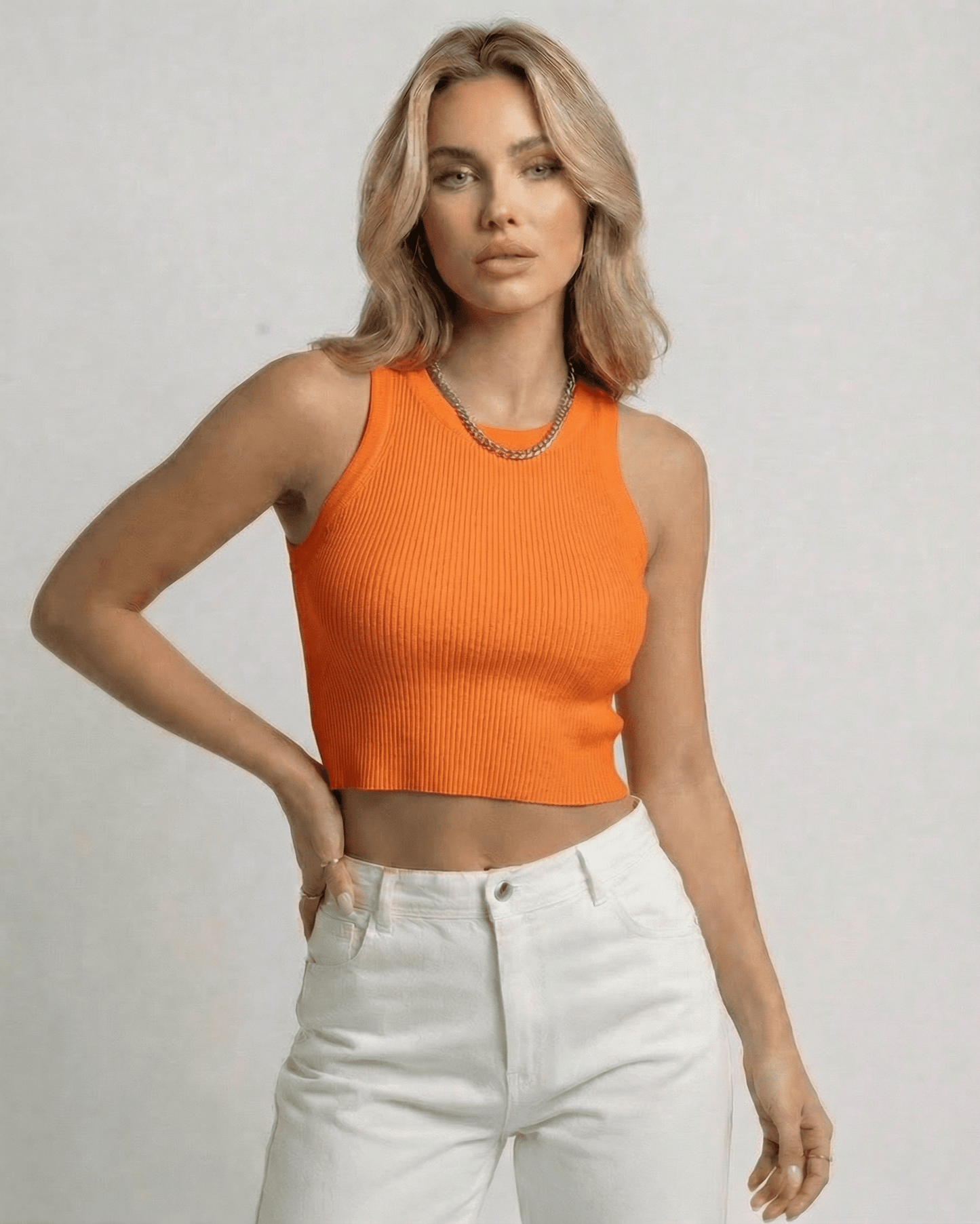 Lauven Capri Top – Women’s ribbed knit cropped sleeveless orange top displayed on model.