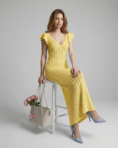 Model wearing Solara Maxi Dress by Lauven, a yellow lace maxi dress with V-neck and ruffle sleeves.