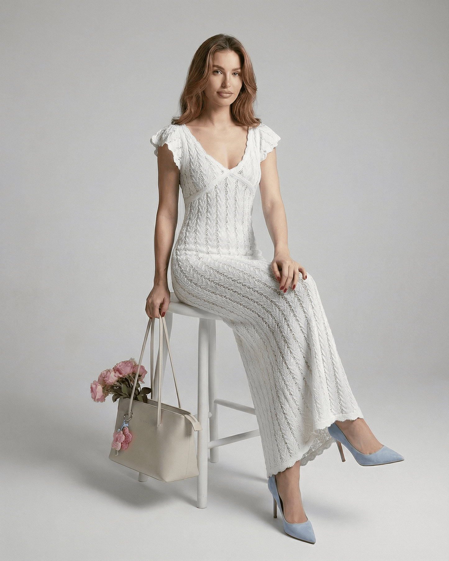 Model wearing the Ivory Lace Maxi from Lauven, showcasing a white cotton V-neck bodycon dress with ruffle sleeves.