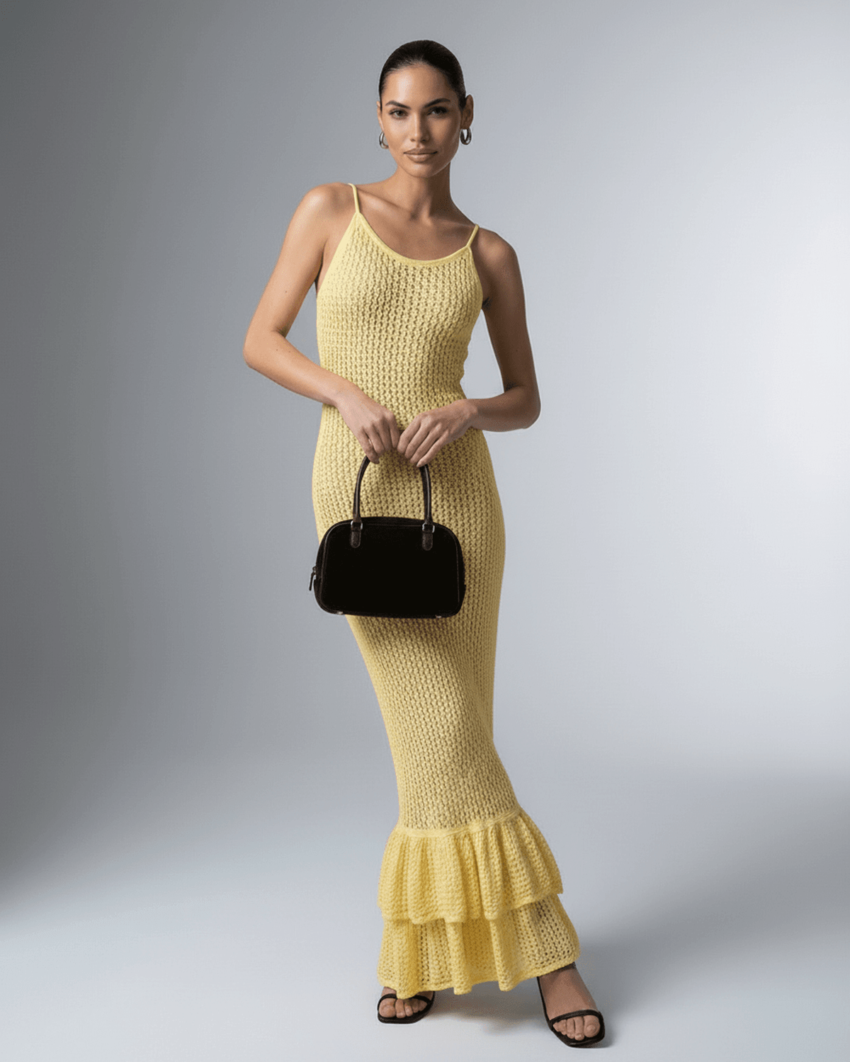 Woman wearing Solara Maxi Dress by Lauven – elegant yellow bodycon design with hollow out detail.