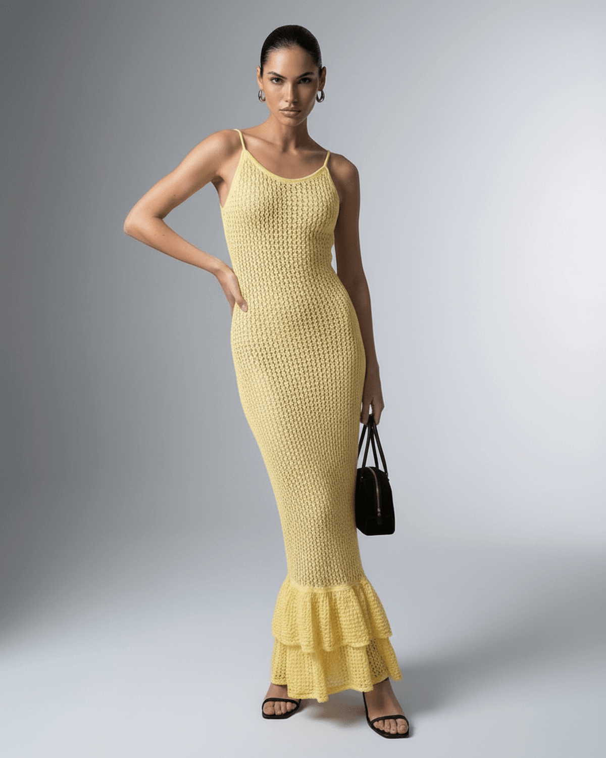 Solara Maxi Dress by Lauven, a yellow bodycon maxi dress with hollow out detail and ruffle hem.