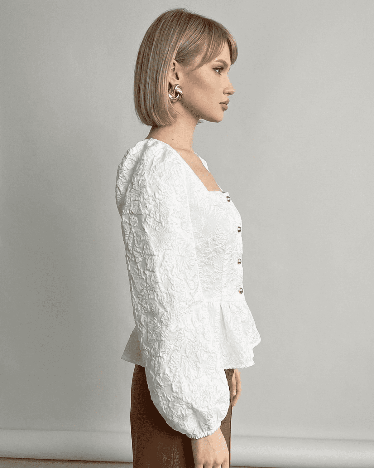 Ivory Corset Top by SLIMONA featuring a jacquard texture and puff sleeves for a refined look.