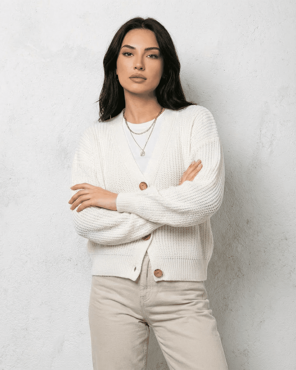 Alba Cardigan by SLIMONA featuring a classic white knit design, soft V-neck, and relaxed fit for timeless style.