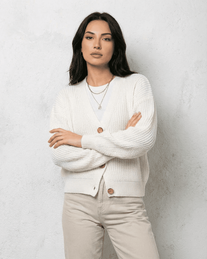 Alba Cardigan by SLIMONA featuring a classic white knit design, soft V-neck, and relaxed fit for timeless style.
