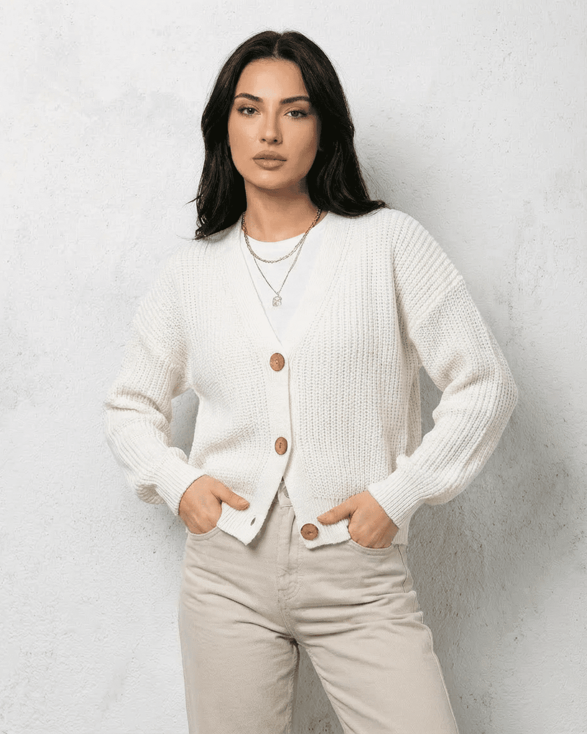 Alba Cardigan by SLIMONA - Classic white knitwear with soft V-neck and button detail, perfect for layering.