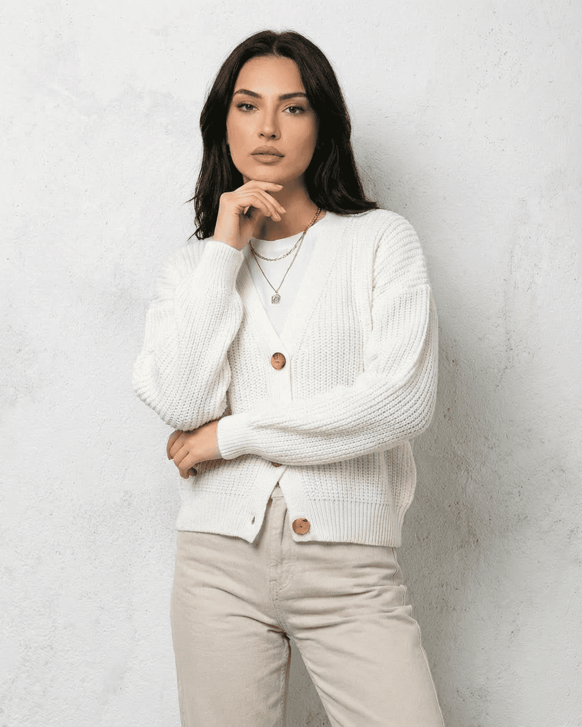 Alba Cardigan from SLIMONA - Classic white knitwear with soft V-neck design and button detail.