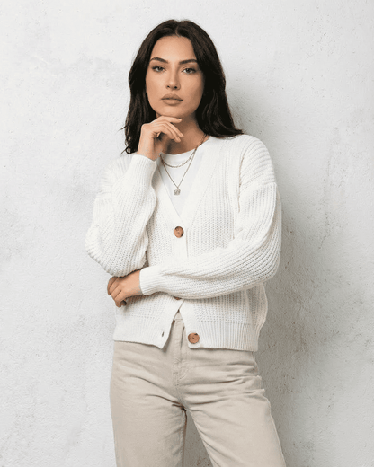Alba Cardigan from SLIMONA - Classic white knitwear with soft V-neck design and button detail.