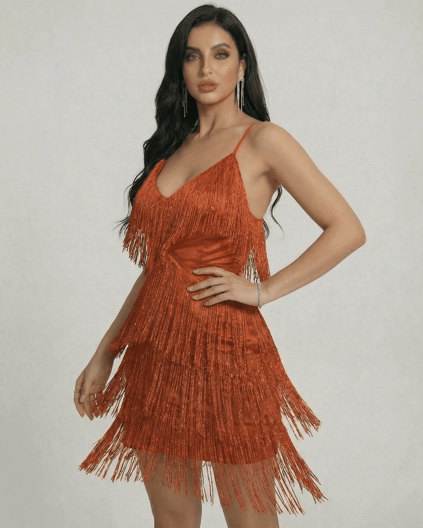 Amber Mini Dress by SLIMONA featuring layered fringe and a sleek V-neck design in warm amber tone.
