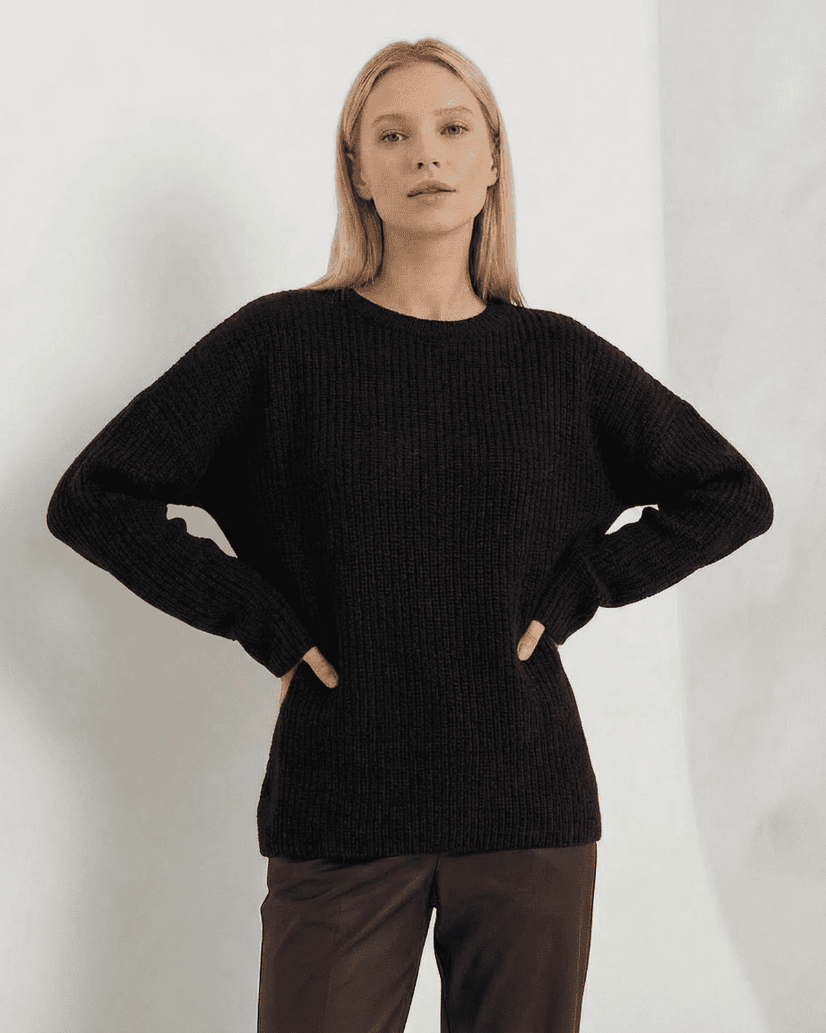 Arden Sweater by SLIMONA in black, featuring loose fit ribbed knitwear and long sleeves.