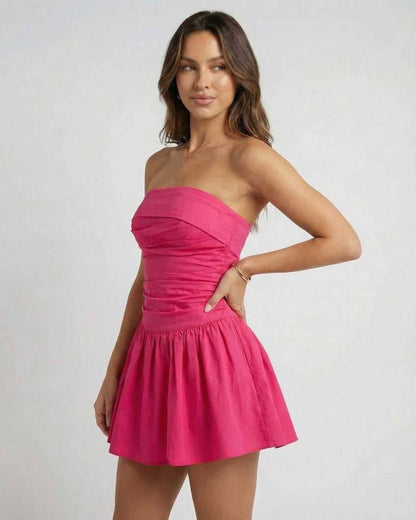 Azalea Mini Dress by Lauven in vibrant pink, showcasing a strapless A-line silhouette and flared skirt.