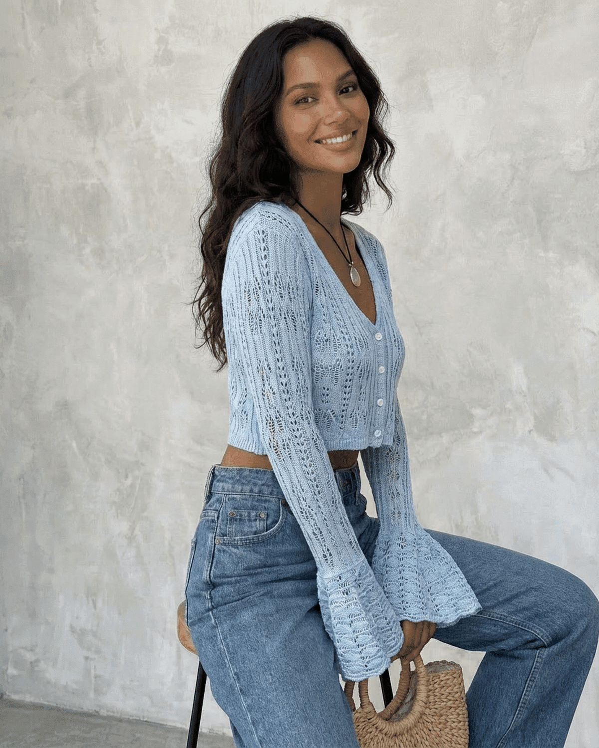Azure Cardigan by SLIMONA in light blue, featuring flare sleeves and a V-neckline, styled with denim. Perfect for casual looks.