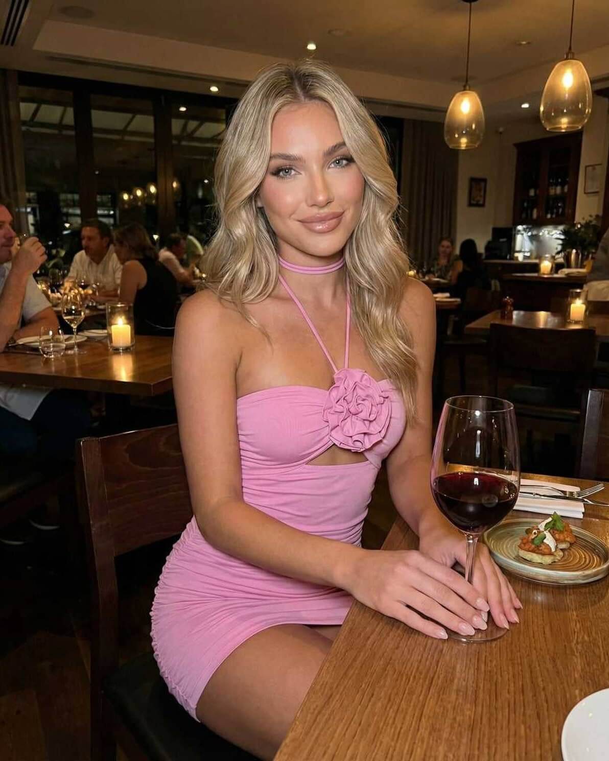 Lauven Blossom Mini Dress in pink, featuring a halter neck and ruched design, perfect for summer outings.