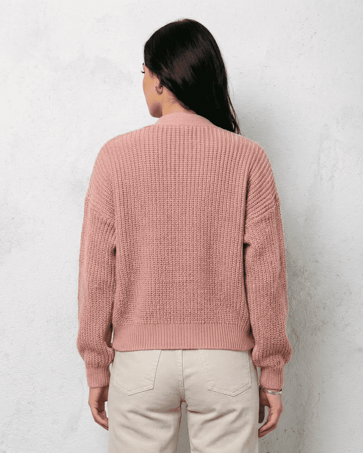 Back view of Blush Cardigan by SLIMONA, showcasing its soft pink knit texture and relaxed fit.