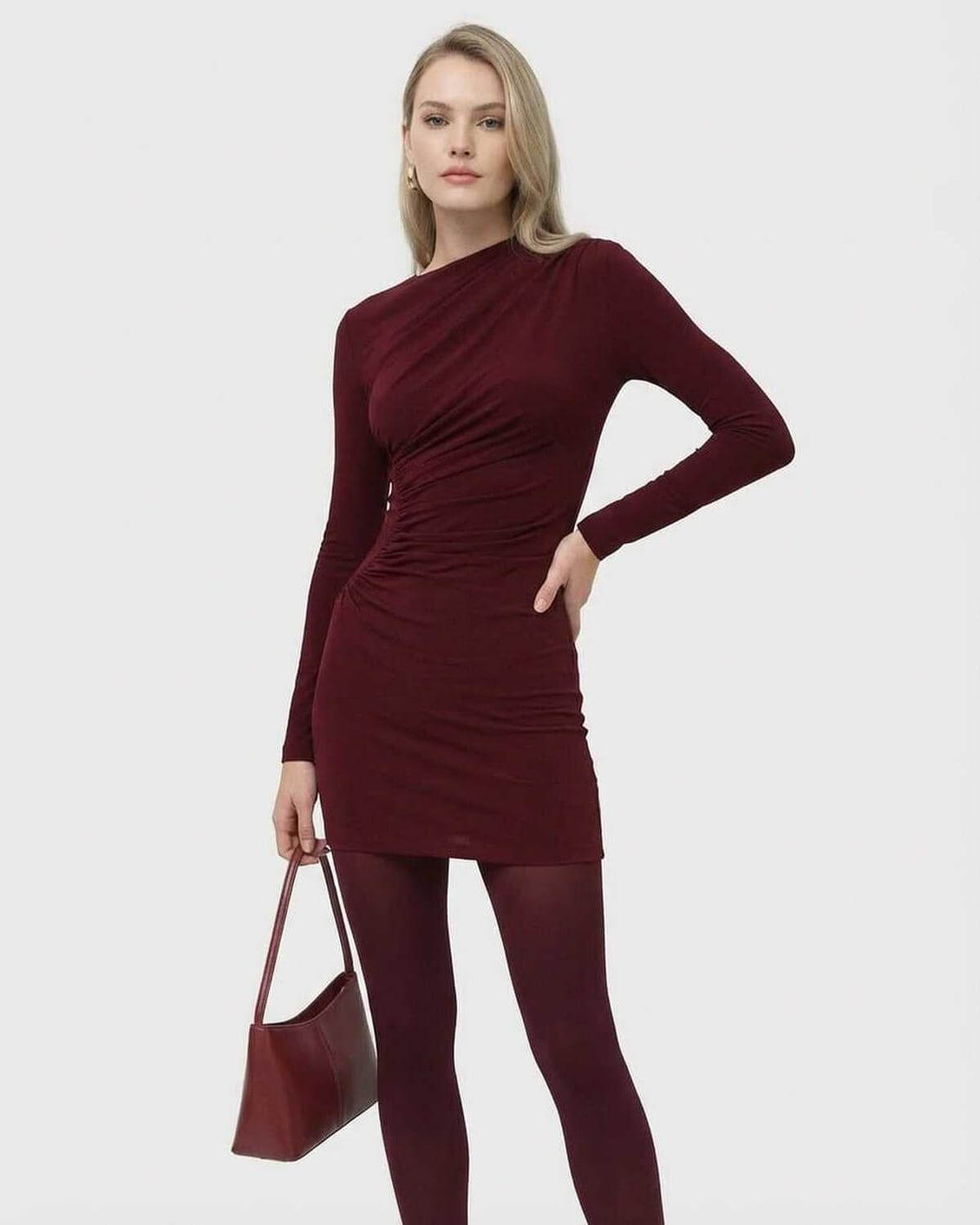 Model wearing Bordeaux Mini Dress by SLIMONA, long sleeve bodycon mini dress in deep wine tone.