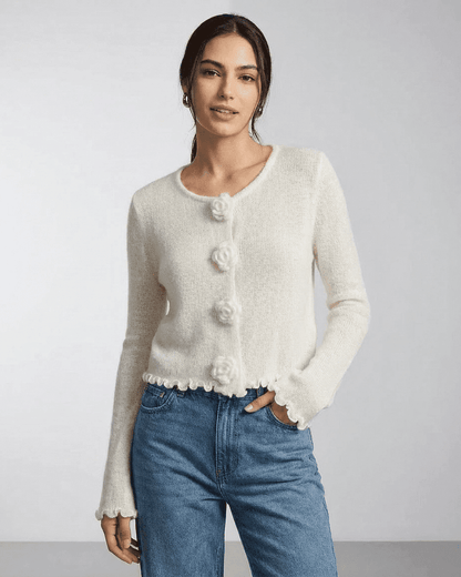 Camellia Cardigan by SLIMONA featuring floral button details and a soft knit texture in a stylish woman’s outfit.