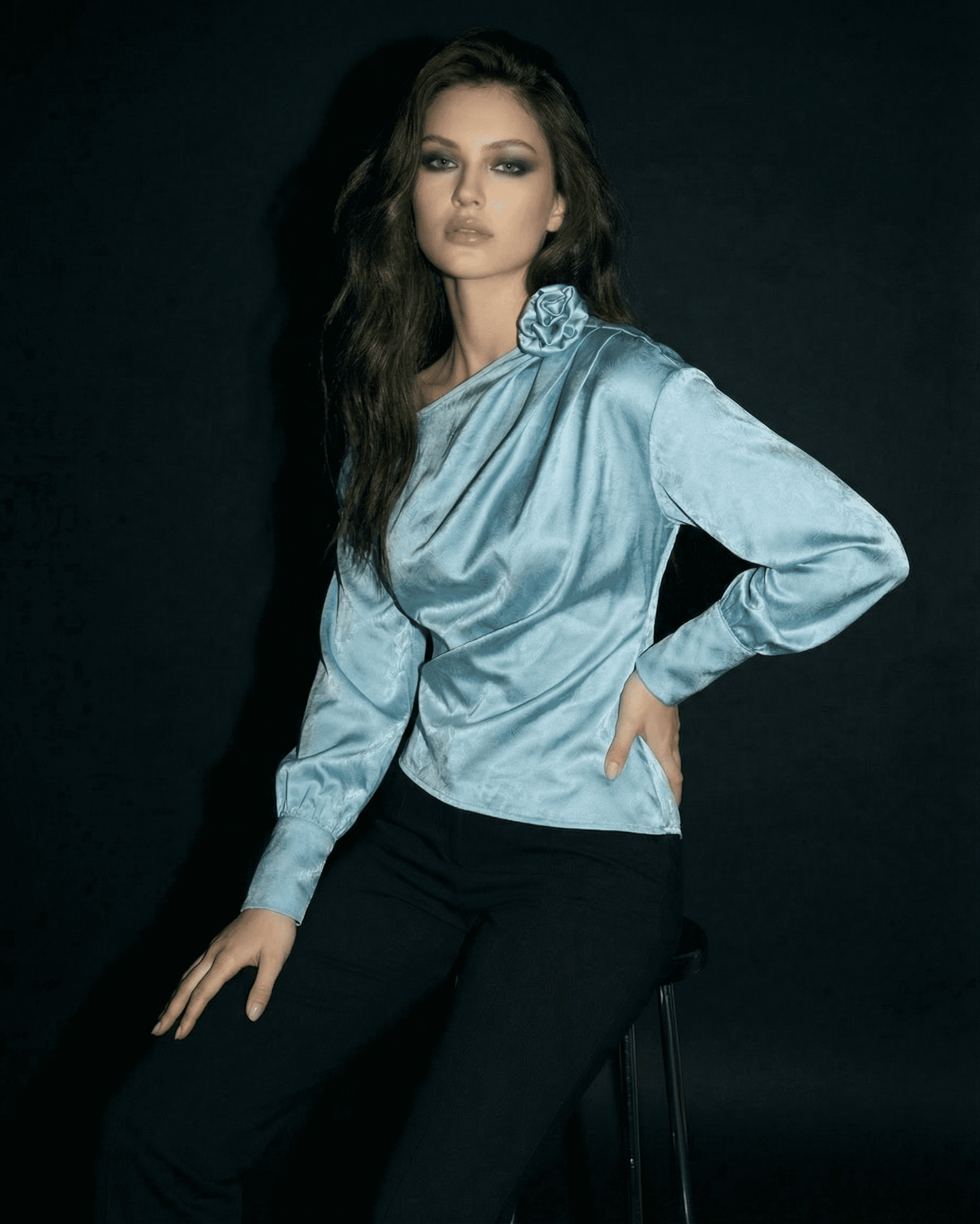 Model wearing the Celeste Blouse by SLIMONA, showcasing an asymmetrical neck and satin-style finish.