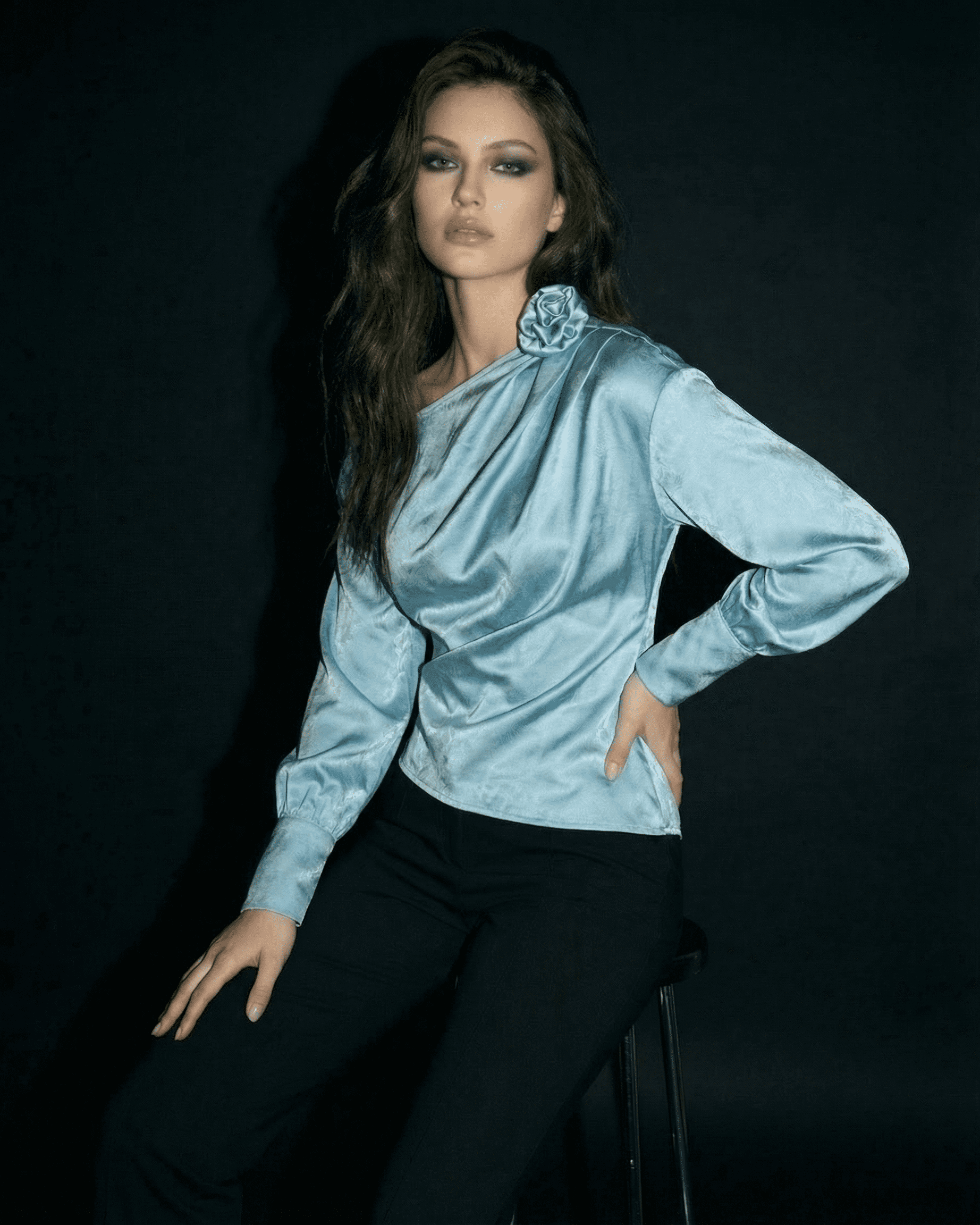 Model wearing the Celeste Blouse by SLIMONA, showcasing an asymmetrical neck and satin-style finish.