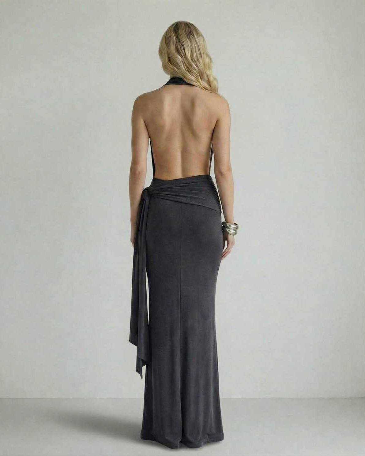 Back view of the Celeste Maxi Dress by Lauven featuring a draped neckline and open back in dark charcoal.
