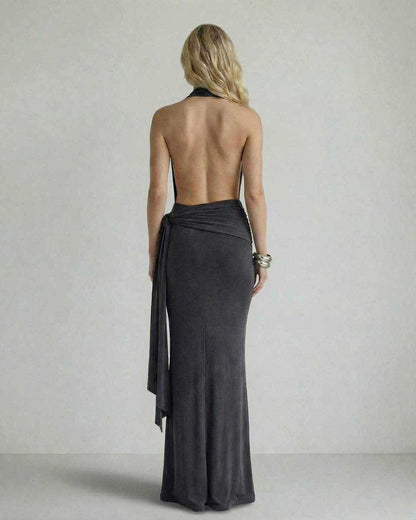 Back view of the Celeste Maxi Dress by Lauven featuring a draped neckline and open back in dark charcoal.