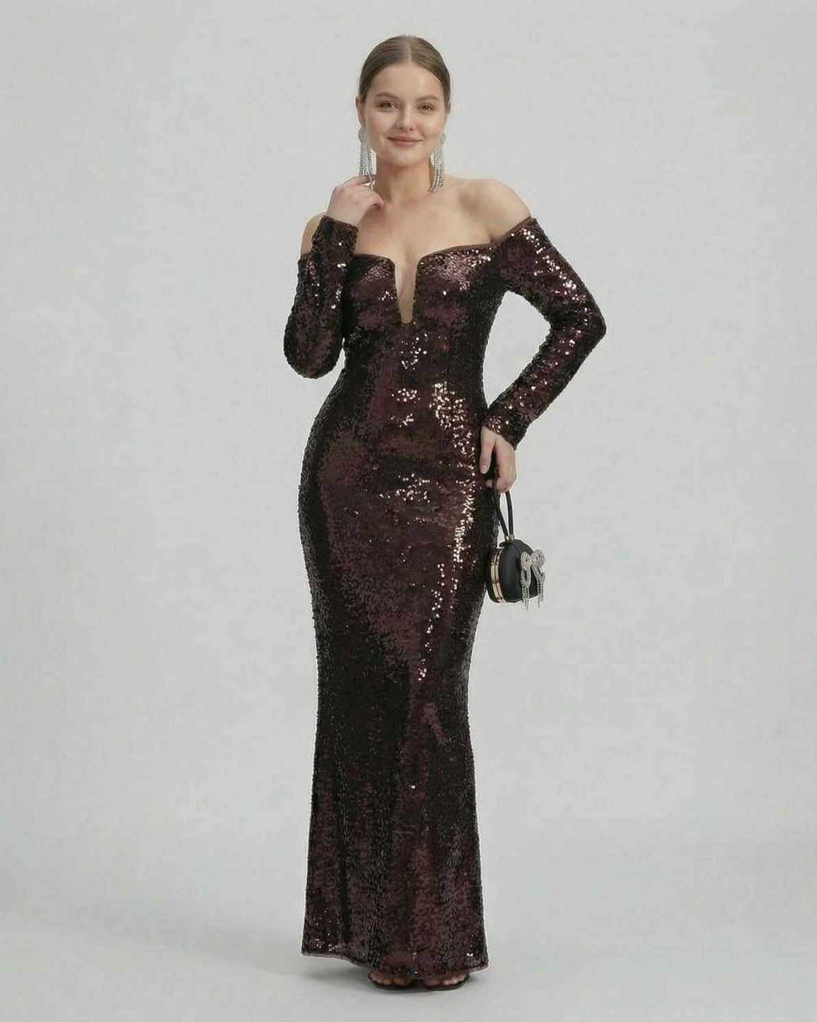 Elegant model in a Celeste Maxi Dress by Lauven showcasing a sequined off-shoulder neckline and fitted silhouette.