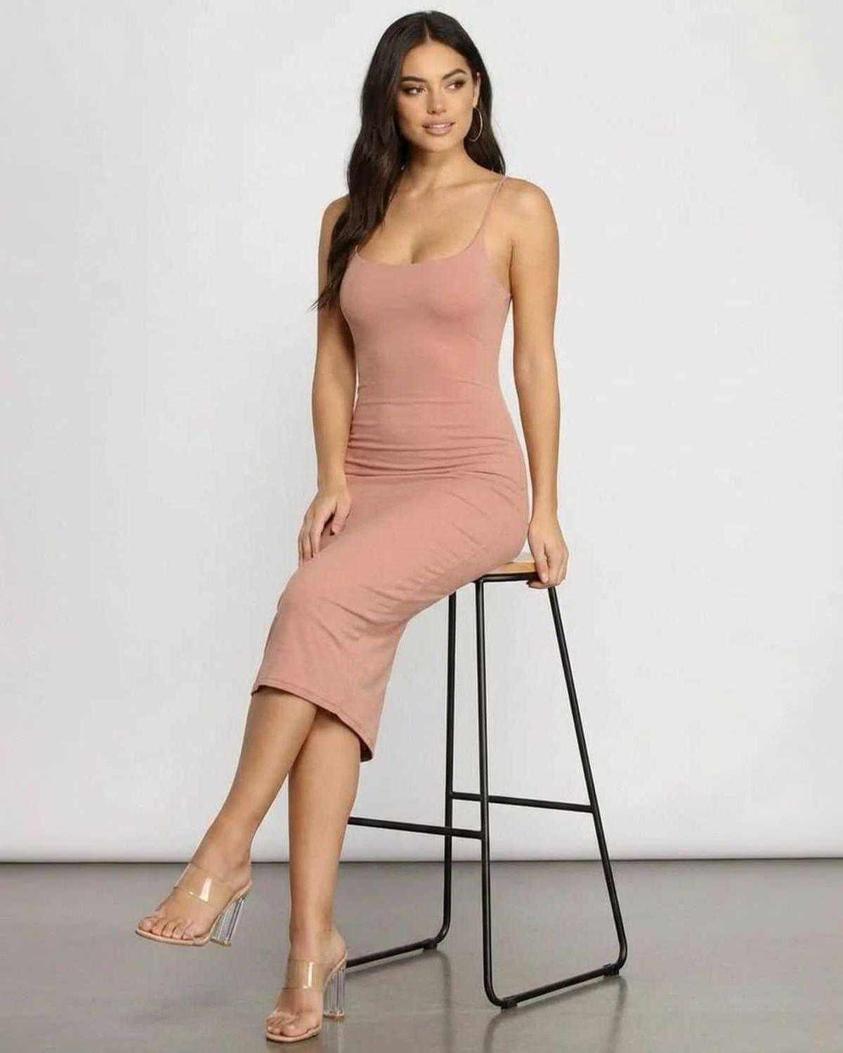 Celeste Midi Dress by SLIMONA, showcasing an elegant curve-hugging silhouette in soft knit fabric.