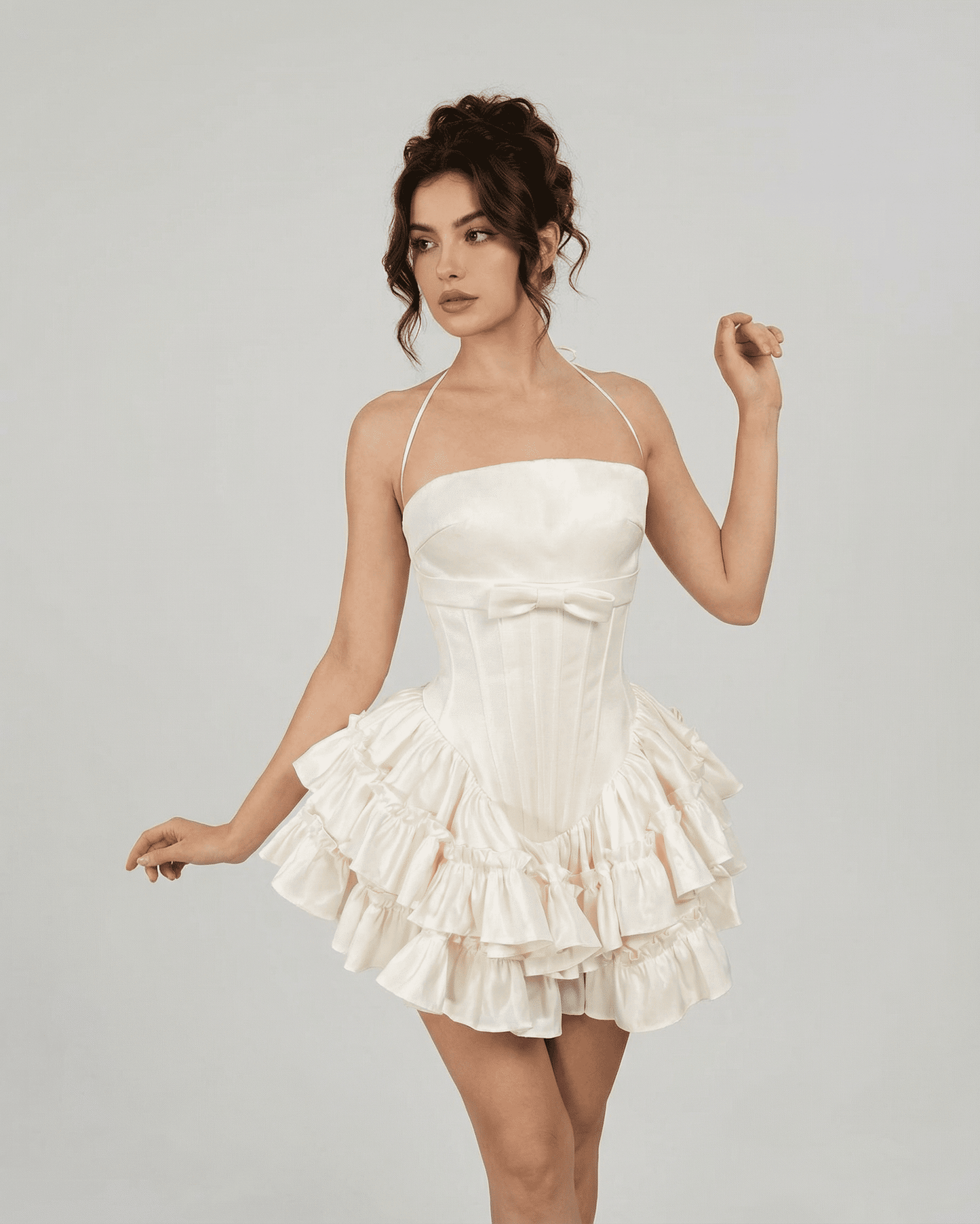 Celeste Mini Dress by SLIMONA, elegant corset-inspired tiered mini dress in soft white, featuring delicate halter straps.