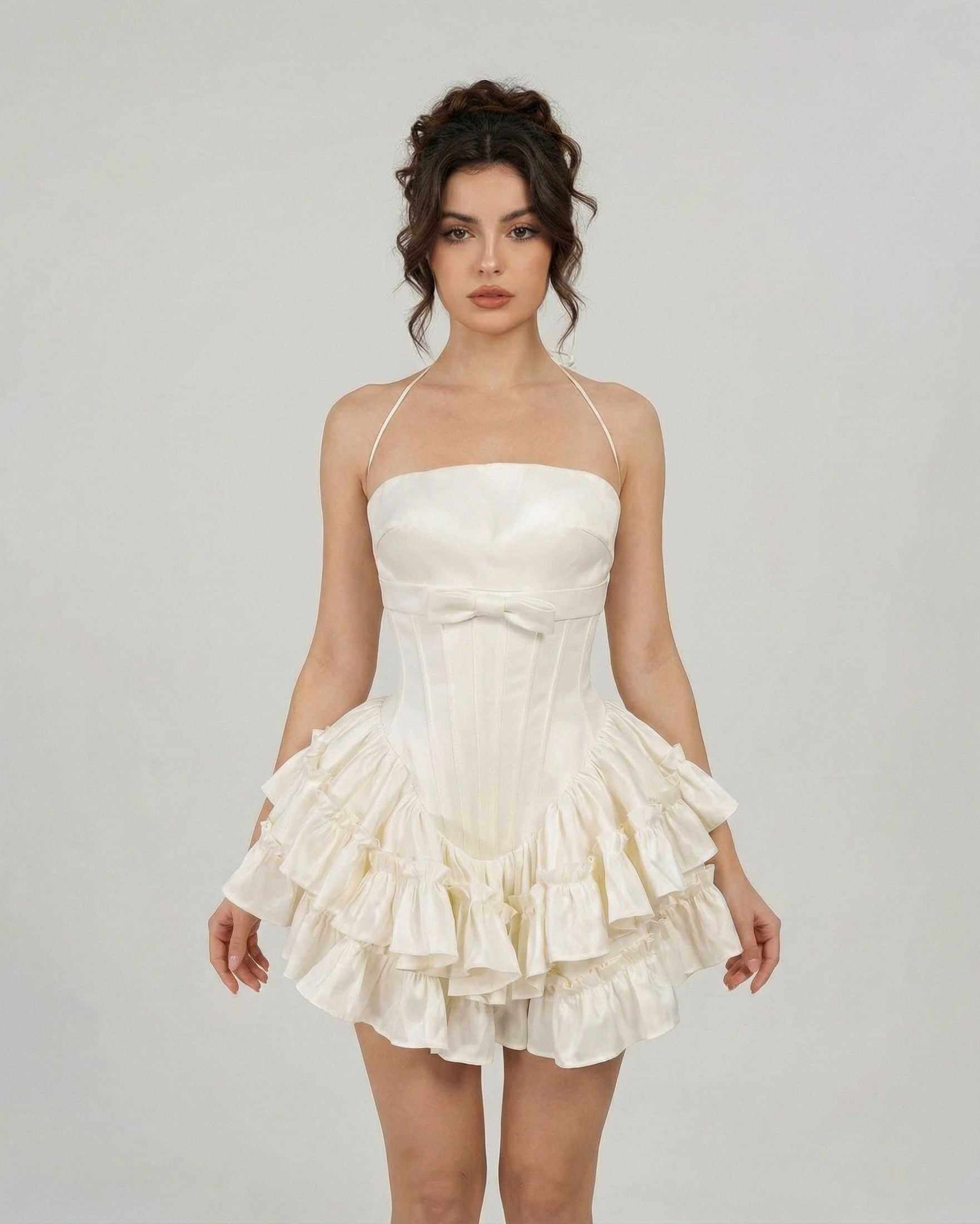 Celeste Mini Dress by SLIMONA, a soft white, corset-inspired tiered mini dress with delicate straps.