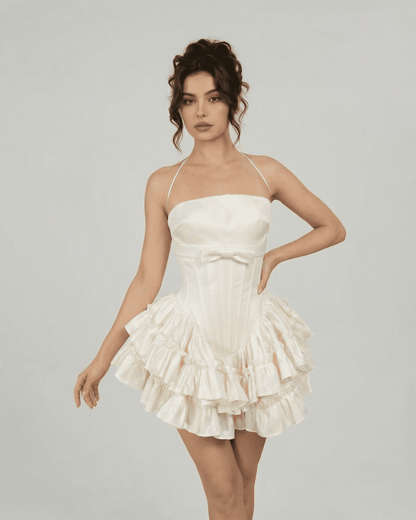 Celeste Mini Dress by SLIMONA in soft white, featuring a corset-inspired design and tiered ruffles.