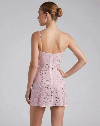 Celeste Mini Dress by Lauven, featuring a pink fabric with rhinestone embellishments and spaghetti straps from the back.