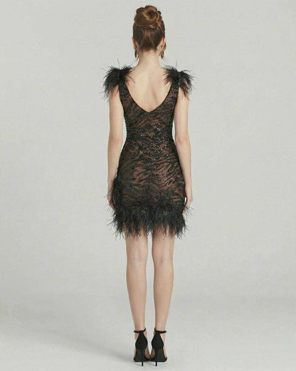 Celeste Mini Dress by Lauven featuring feathered detailing and a sequined black silhouette from the back.