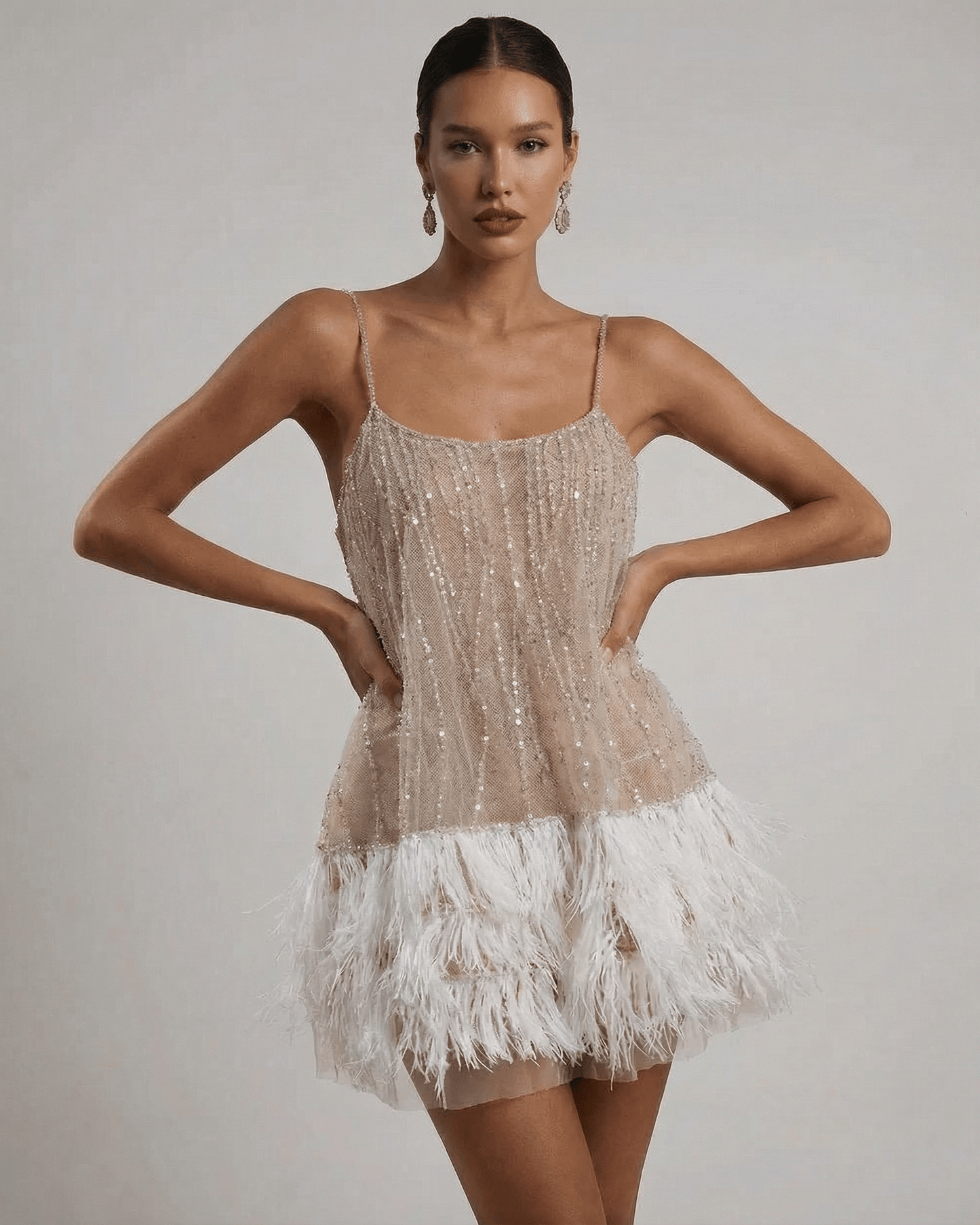 Celeste Mini Dress by SLIMONA - Sequin Tulle Fairycore design with feather tassel hem, showcasing elegance and glamour.