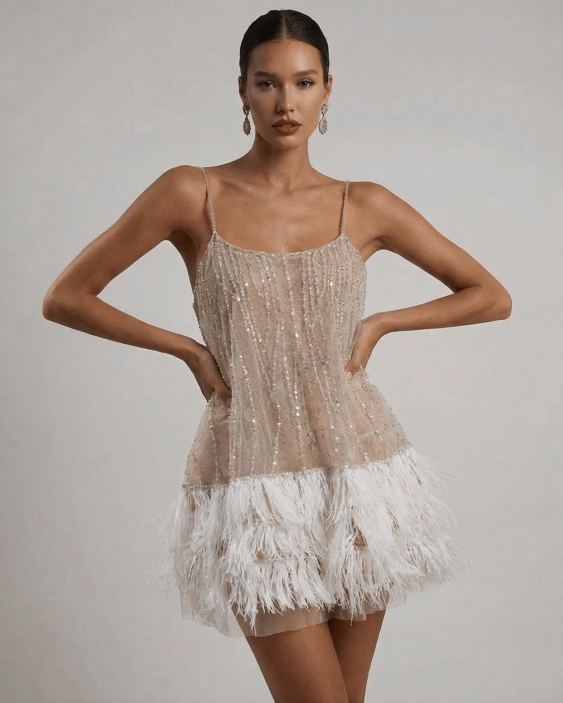 Celeste Mini Dress by SLIMONA - Sequin Tulle Fairycore design with feather tassel hem, showcasing elegance and glamour.