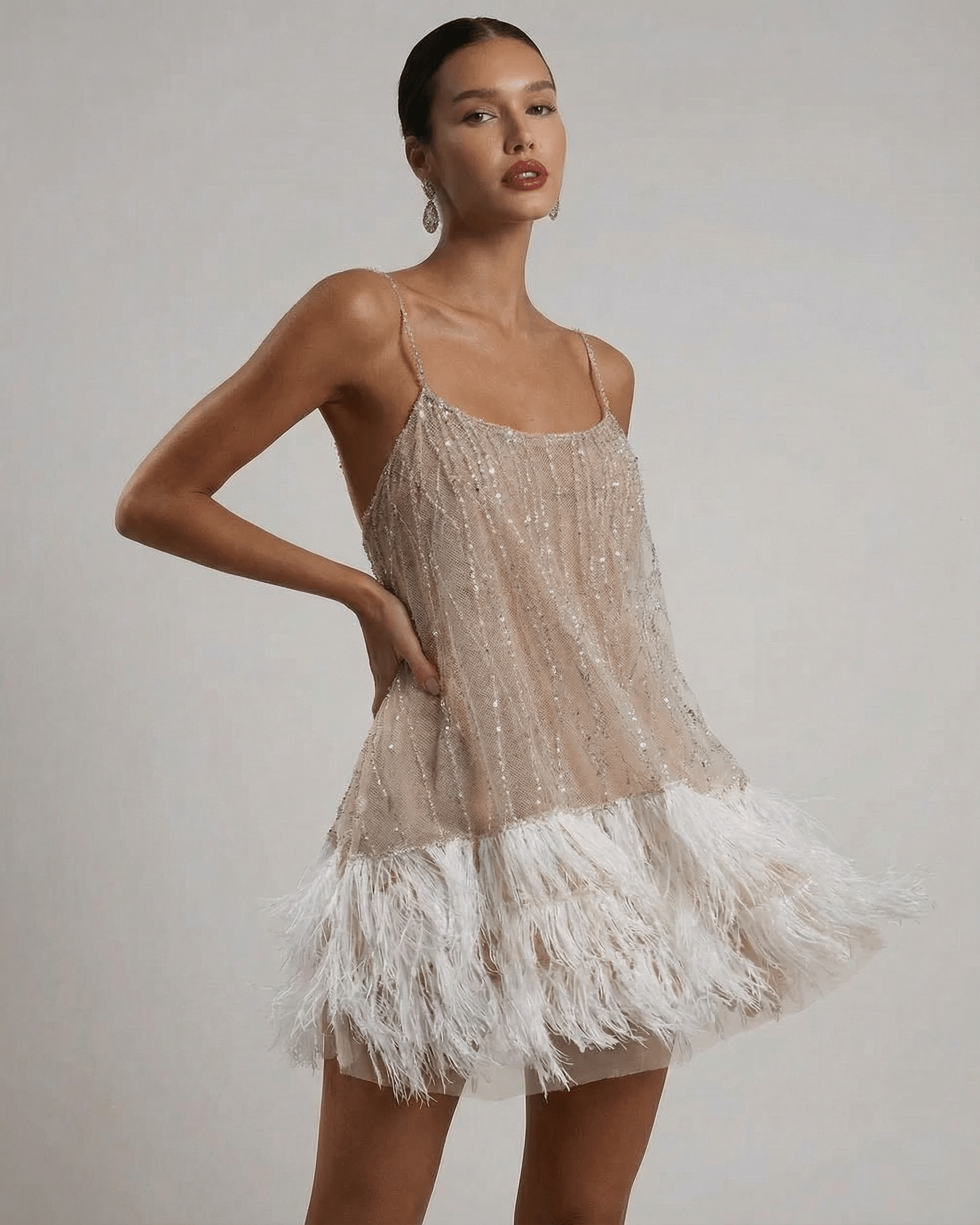Celeste Mini Dress by SLIMONA, a sequin tulle fairycore mini dress with feather tassel hem in soft hues.