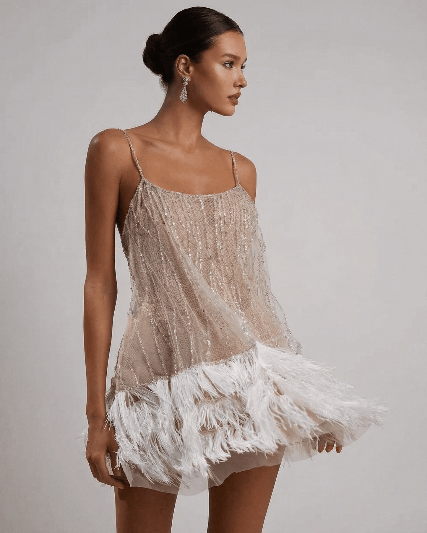 Celeste Mini Dress by SLIMONA, a sequin tulle dress with feather tassel hem, radiating elegance and glamour.