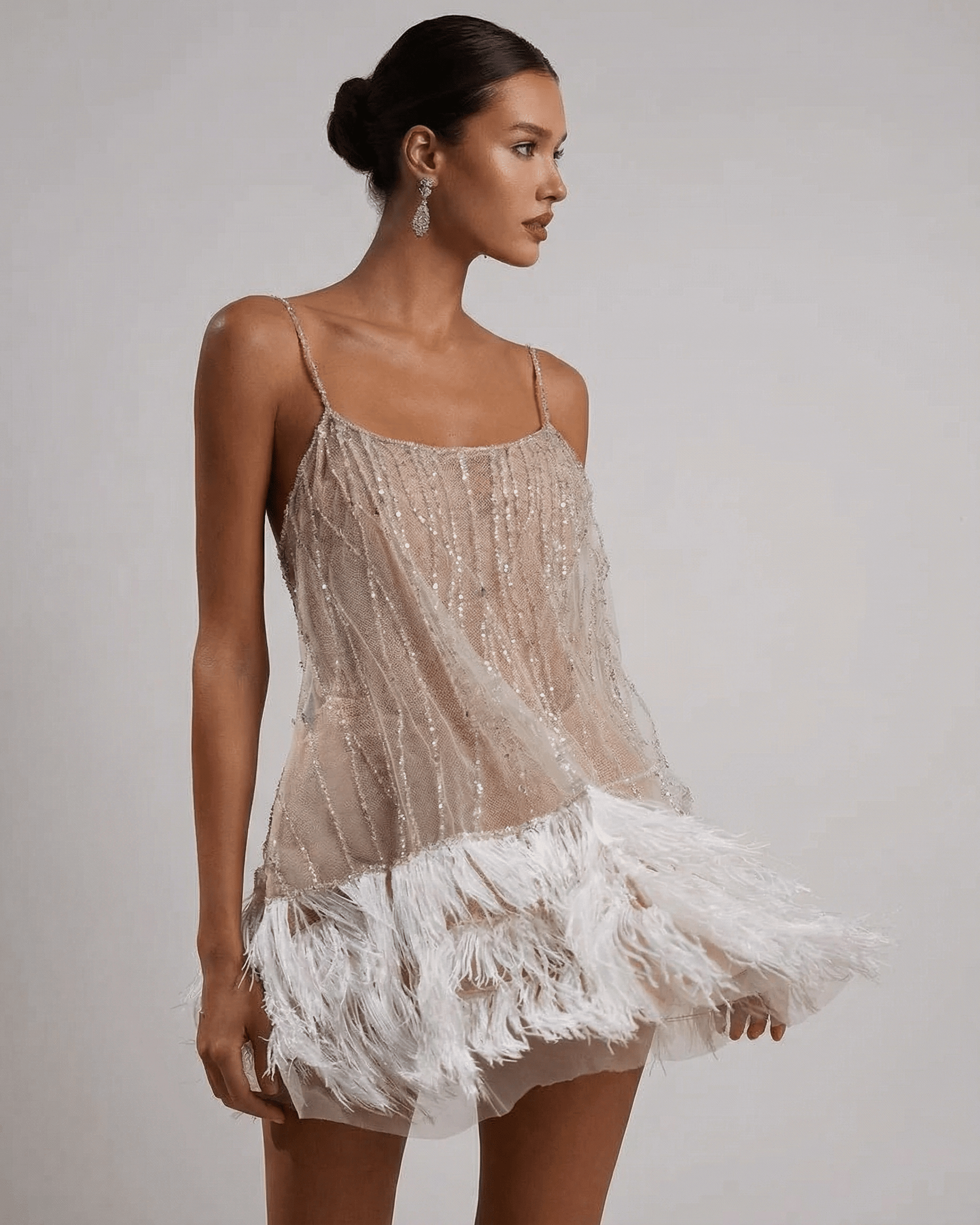 Celeste Mini Dress by SLIMONA, a sequin tulle dress with feather tassel hem, radiating elegance and glamour.