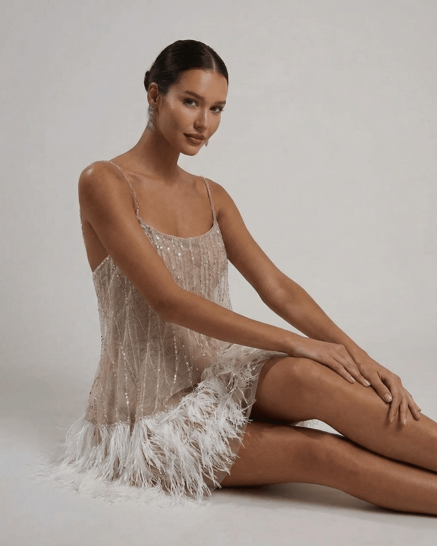 Celeste Mini Dress by SLIMONA, featuring sequin tulle and feather tassel hem, showcasing modern glamour and elegance.