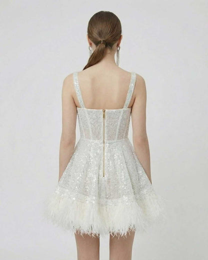 Celeste Mini Dress by SLIMONA - Back view of silver sequin mini dress with faux fur hem and spaghetti straps.