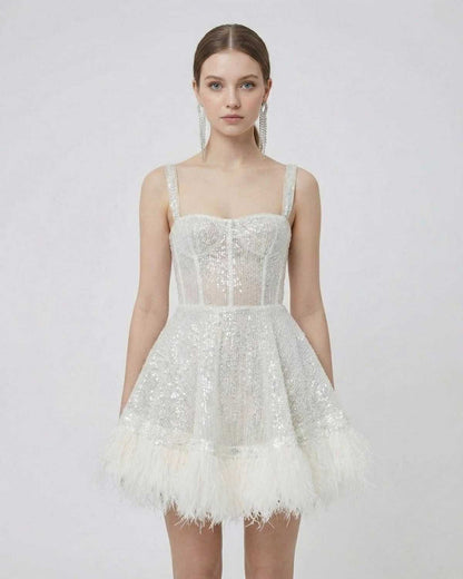 Celeste Mini Dress from SLIMONA, a silver sequin A-line mini dress with faux fur hem and spaghetti straps.