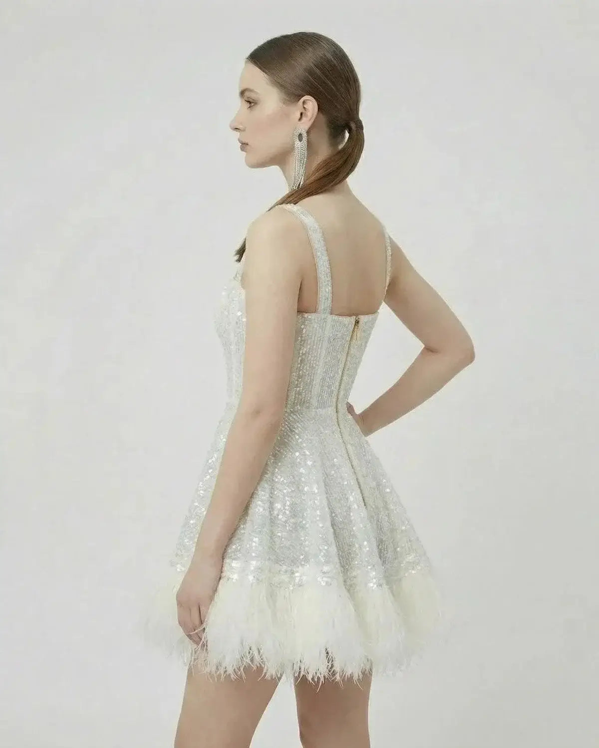 Celeste Mini Dress by SLIMONA featuring a silver sequin A-line design with faux fur hem, perfect for elegant occasions.