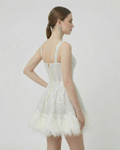 Celeste Mini Dress by SLIMONA, showing the back view with sequin design and faux fur hem details.