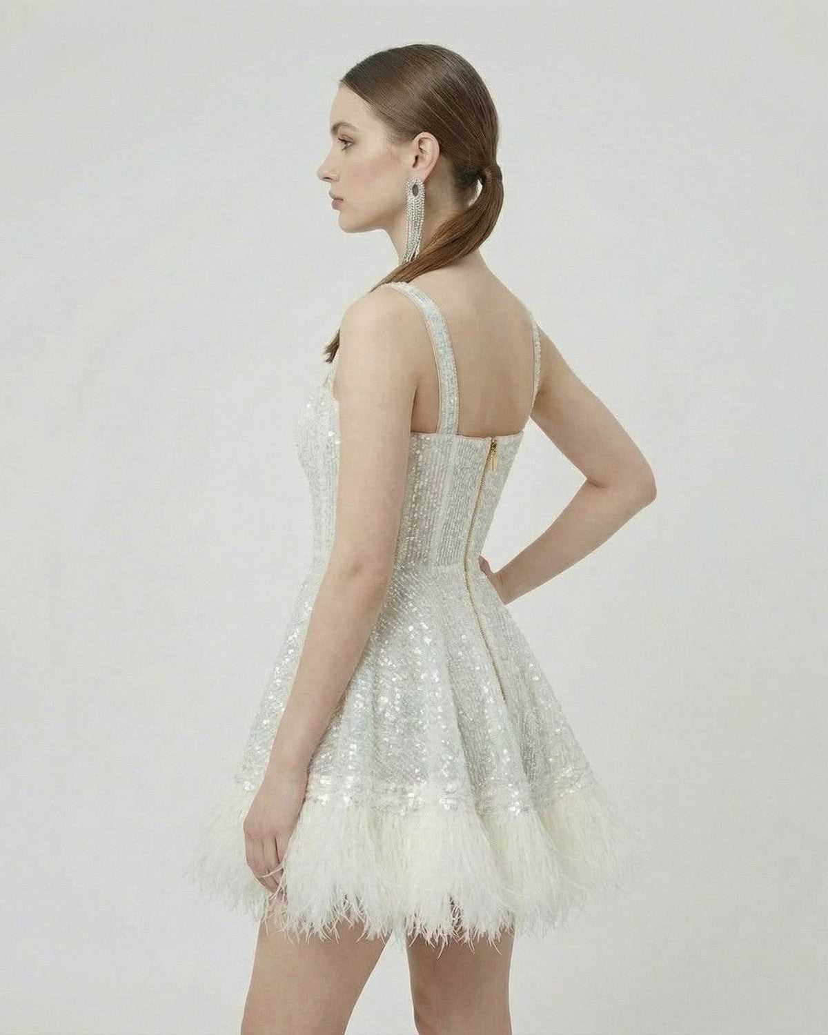 Celeste Mini Dress by SLIMONA - Silver Sequin A-Line Mini Dress with Faux Fur Hem showcasing a modern silhouette.