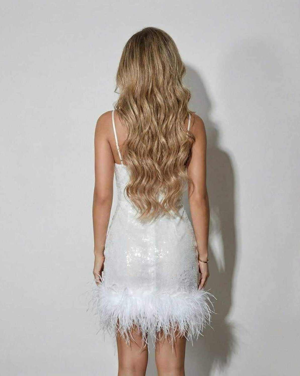 Celeste Mini Dress by Lauven with feather hem and sequin detail, showcasing a stylish back view.