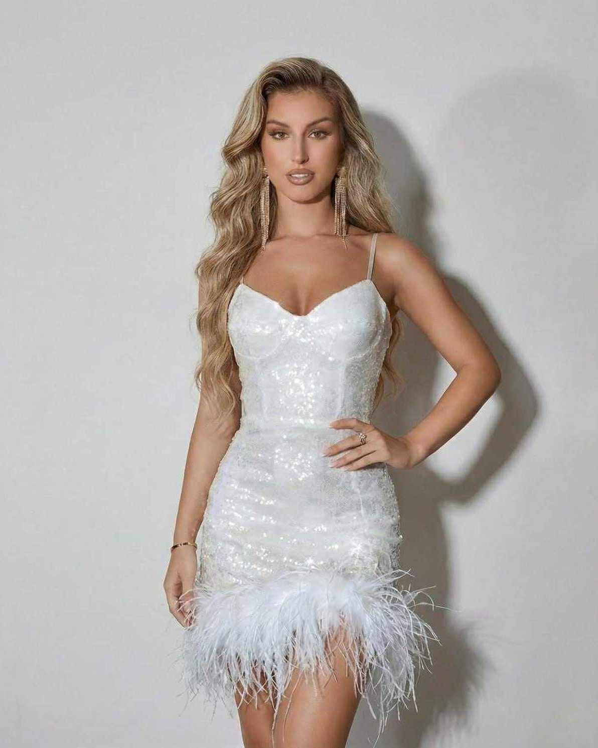 Celeste Mini Dress by Lauven featuring a feather hem and sequin detail, perfect for elegant evening wear.