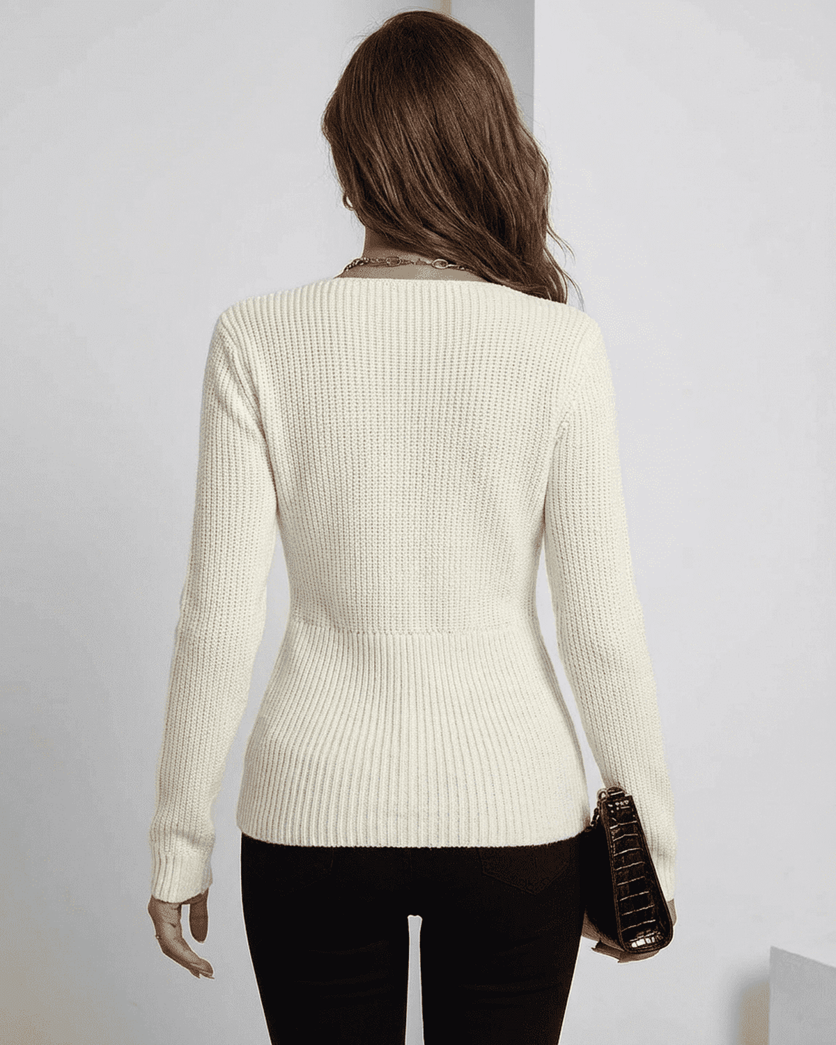 Back view of the Celeste Pullover by SLIMONA, a ribbed slim fit v-neck sweater in ivory.