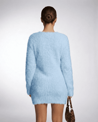 Back view of a model wearing a light blue Celeste Sweater by SLIMONA, showcasing its plush knit texture and stylish fit.
