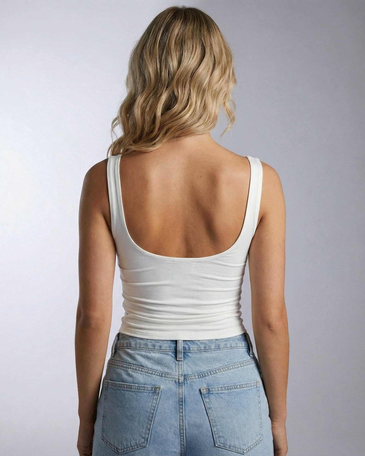 Celeste Top by SLIMONA, back view of draped sleeveless top in white, showcasing a modern elegant style.