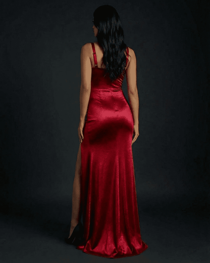Celestia Maxi Dress by SLIMONA, showing the back view of a luxurious red satin design with a thigh-high split.